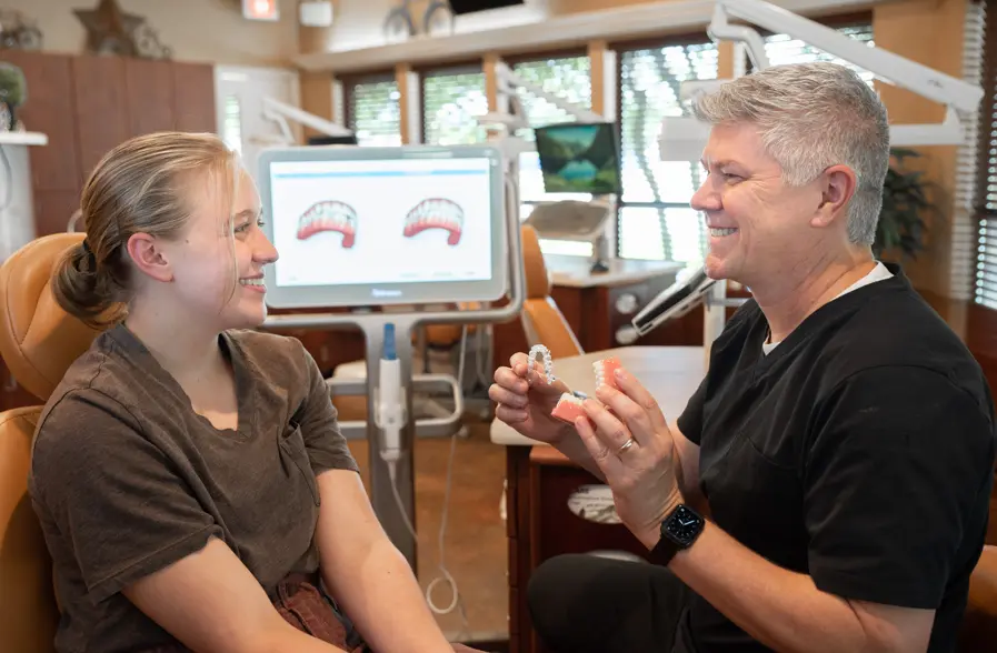 Dr. Cramer Showing Teenage Patient How Invisalign Clear Aligners Works