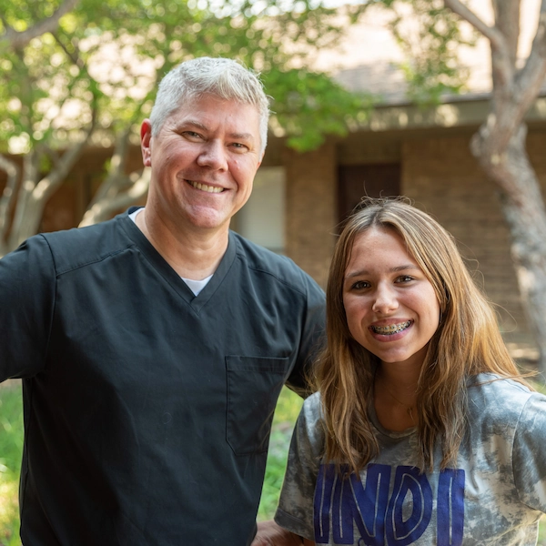 a patient of Dr. Cramer's with metal braces in Denton